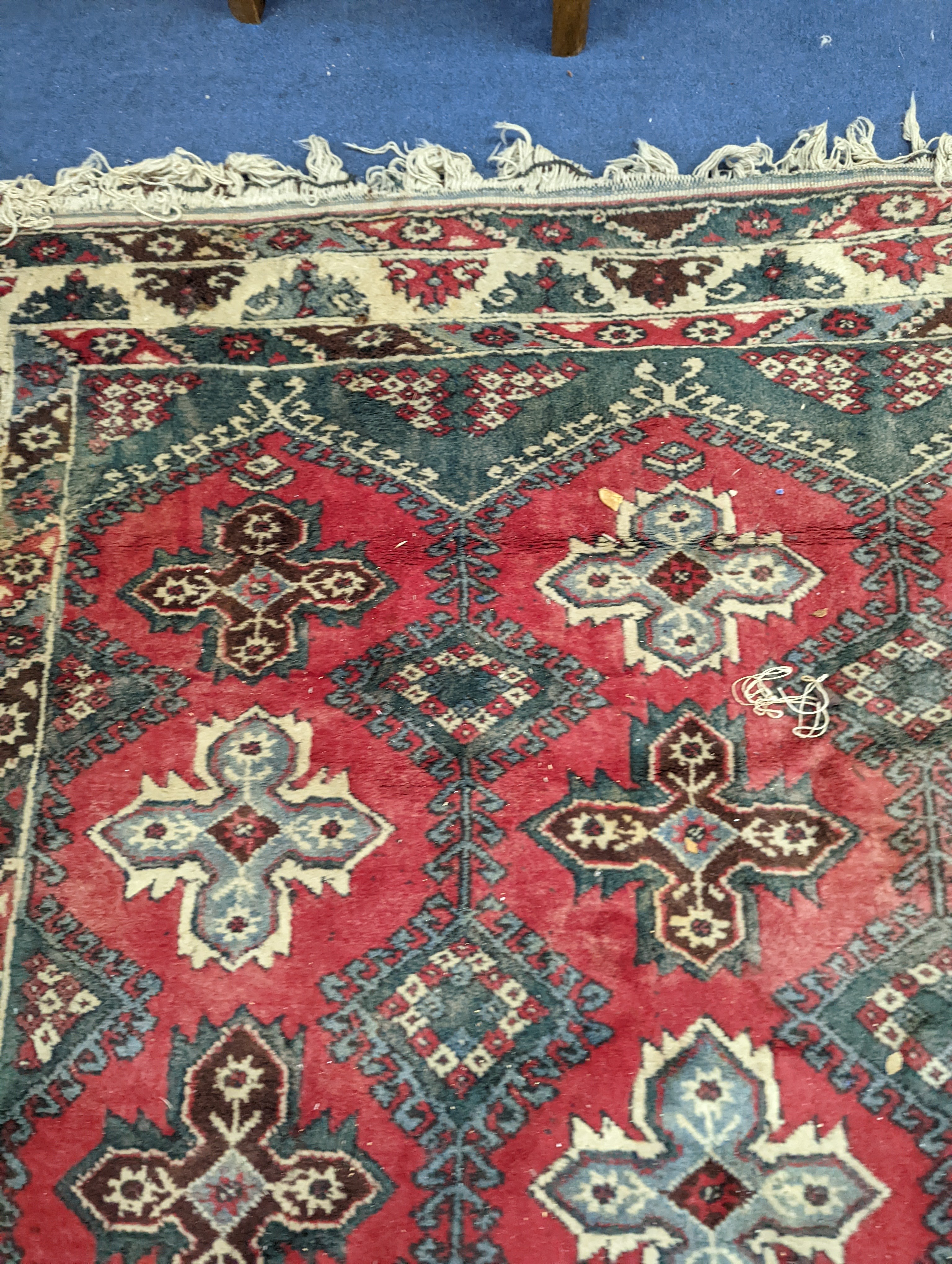 A Caucasian style red ground carpet, 286 x 210cm